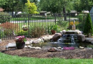 A slight disagreement can turn into a costly legal battle A serene backyard pond with a waterfall and rocks in Batavia, IL