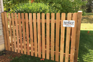 The wooden fence in garden at Batavia, IL A wooden fence with a sign, located in Batavia, IL