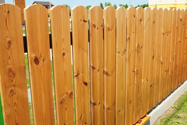 New wooden fence in the garden. New wooden fence in the garden.