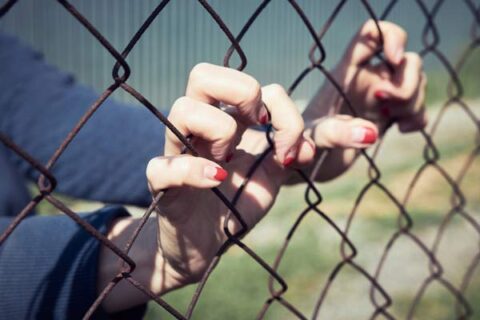 hands on fence