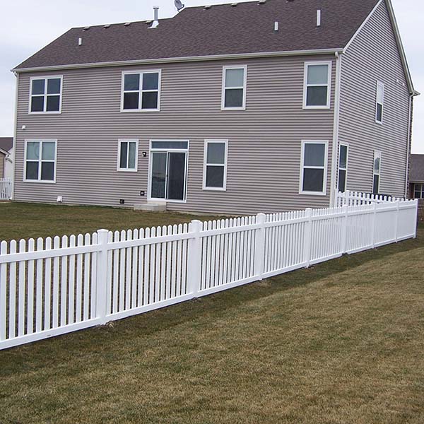 A white picket fence surrounds a charming house in a serene neighborhood in Batavia, IL