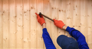 Contractor worker is holding a hammer