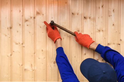 Contractor worker is holding a hammer